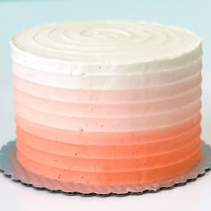 a white cake with pink and orange frosting