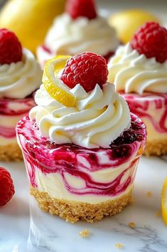 several small desserts with raspberries and lemon slices