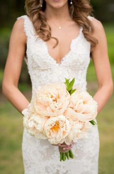 a bride holding a bouquet of flowers in her hands