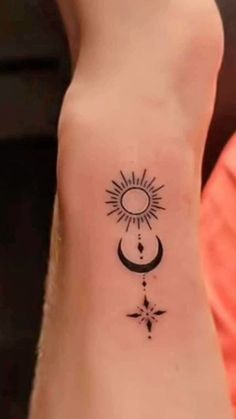 a person with a small tattoo on their foot and the sun in the sky above them