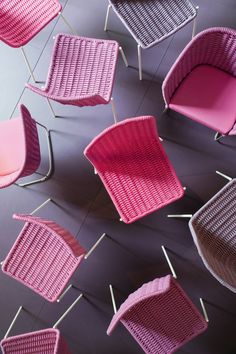 pink and brown chairs are arranged on the floor