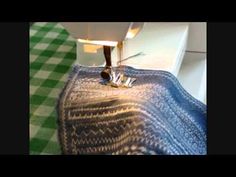 the sewing machine is on top of the blue and white quilted tablecloths