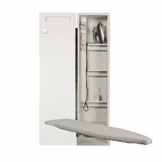 an ironing board is in front of a cabinet with its door open and it's contents on the bottom shelf