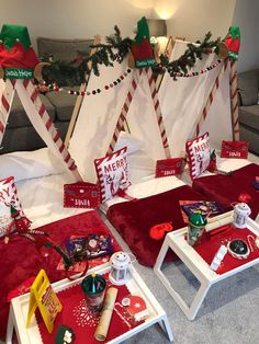 two beds covered in red blankets with christmas decorations on them