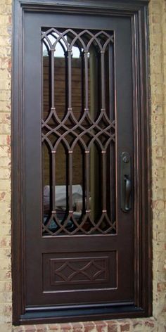 the front door is made of wood and has an iron grill design on it's side