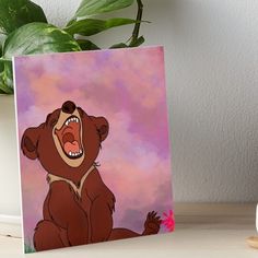 a brown bear with its mouth open on a pink and purple background art board print