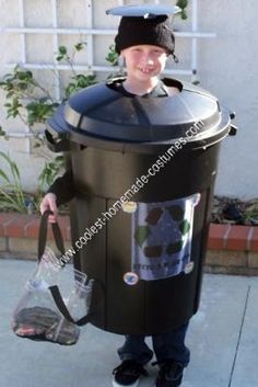 a young boy dressed up in a garbage can costume