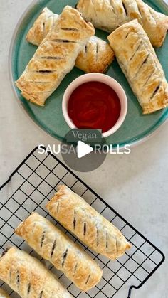 several pastries on a cooling rack with ketchup and dipping sauce next to them