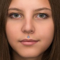 a close up of a person wearing a nose ring with a diamond in the middle