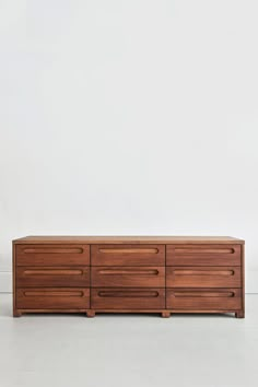 a large wooden dresser sitting on top of a white floor