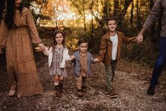 a family holding hands and walking in the woods