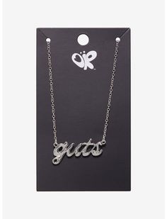 a necklace with the word guts on it