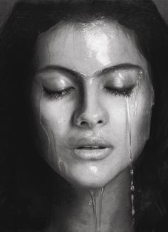 a woman with her eyes closed and water dripping from her face, in black and white