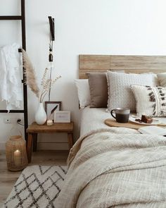 a bed room with a neatly made bed and a coffee cup on the end table