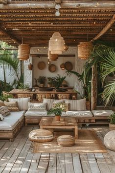 an outdoor living area with couches, tables and potted plants on the deck