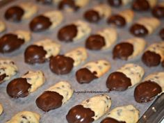 chocolate - covered cookies are lined up on a baking sheet and ready to be baked