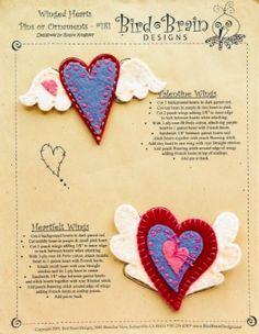 two red and blue hearts with angel wings on top of a piece of parchment paper