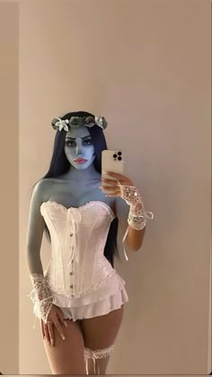 a woman in white corset taking a selfie