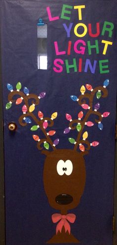 a door decorated with the words let your light shine and a reindeer's head