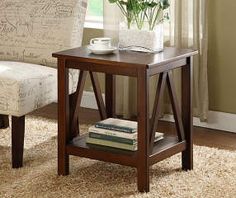 a chair and table in a room with a rug on the floor next to it