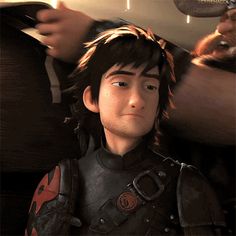 an animated image of a young man in armor looking at the camera while being filmed