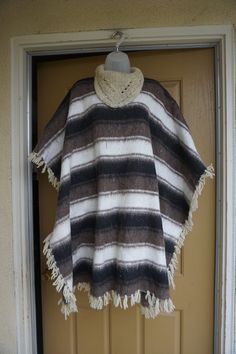 "Vintage cape - not sure of the material but its soft thick and warm. Condition - good but can use a cleaning. Measurements taken across front laid flat 43\" across 37\" length" Cozy Poncho For Cold Weather, Winter Poncho In One Size Cape Style, Winter Poncho One Size Cape, One Size Winter Cape Poncho, Cozy Wool Poncho Cape, Cozy Winter Cape Poncho, Cozy Long Sleeve Wool Cape, Cozy Brown Wool Poncho, White Cozy Winter Poncho