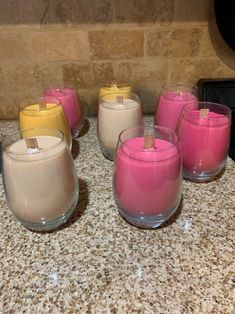 candles are lined up on a counter top