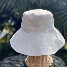 A beige linen sun hat for beach days and summer fun. This sun hat for women has a nice wide brim to protect your whole face and even your neck and chest. This hat folds easily to bring along in your bag. This hat is made from a medium weight homespun linen and cotton blend fabric in a neutral beige color. Inside liner is white cotton. I used a stiff interfacing for brim to keep it's shape. Brim measures 4.5" Crown depth is 3.5". Contact me for custom fit option. SIZES AVAILABLE S - measures 22.5 Lightweight Natural Bucket Hat For Travel, Natural Lightweight Bucket Hat For Travel, Summer Bucket Hat With Flat Brim For Travel, Summer Travel Bucket Hat With Flat Brim, Lightweight Wide Brim Sun Hat For Beach Season, Natural Brimmed Bucket Hat For Travel, Natural Bucket Hat With Short Brim For Travel, Lightweight Beachy Sun Hat In Beige, Lightweight Beige Beachy Sun Hat