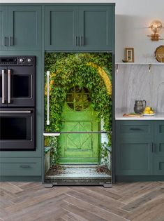 an open door to a kitchen with green doors