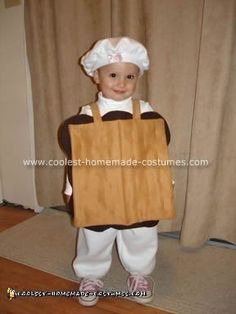 a child dressed as a chef holding a bag