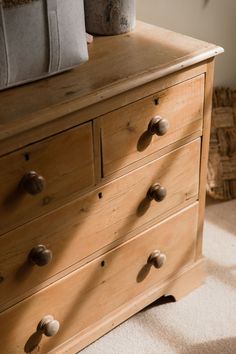 a wooden dresser with several drawers and knobs