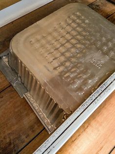 a metal tray sitting on top of a wooden floor