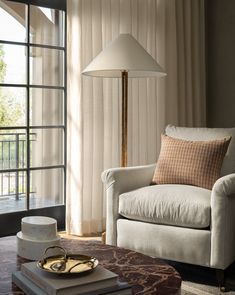 a living room filled with furniture and a lamp