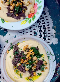 two plates filled with food on top of a table