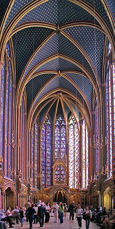 the inside of a large cathedral with stained glass windows