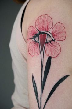 a woman's arm with a red flower tattoo on the left side of her body