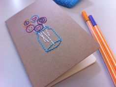 a notebook with some crochet designs on it and two pencils next to it