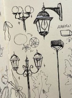 sketches of street lamps and signs on a white sheet with black marker writing in it