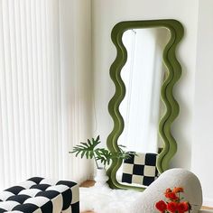 a living room filled with furniture and a large mirror on top of a wooden floor