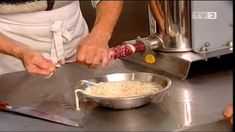 a person is cooking pasta in a bowl