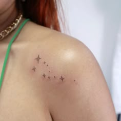 a woman's shoulder with stars on it