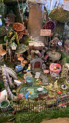 an assortment of fairy houses and figurines on display