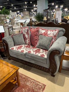 a living room filled with furniture and lots of pillows on top of it's couches