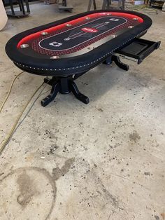 a black table with red lights on it in a room full of other tables and chairs