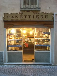 the entrance to a bakery with its lights on