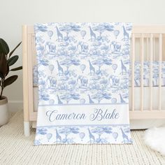 a baby crib with a blue and white blanket that says canon bleke