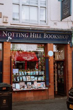 there is a book shop on the side of the street in front of a building