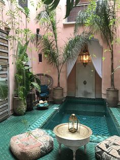 an indoor swimming pool surrounded by potted plants