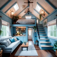 a living room filled with furniture and stairs