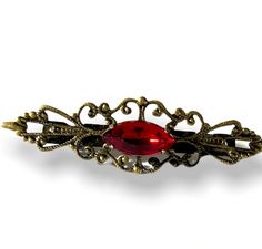 "Ms. Hepurn red siam Hair Barrette-Filigree-Bronze-Vintage Style Hair Clip Vintage Style. Antiqued bronze barrette with highly defined filigree scroll work, embellished with a Siam Red vintage navette. A fabulous touch to any do. measures 2 1/4\"x 1/2\"" Red Hair Clips, Victorian Hairstyles, Red Accessories, Scroll Work, Red Vintage, Style Hair, Turbans, Hair Barrettes, Red And Gold